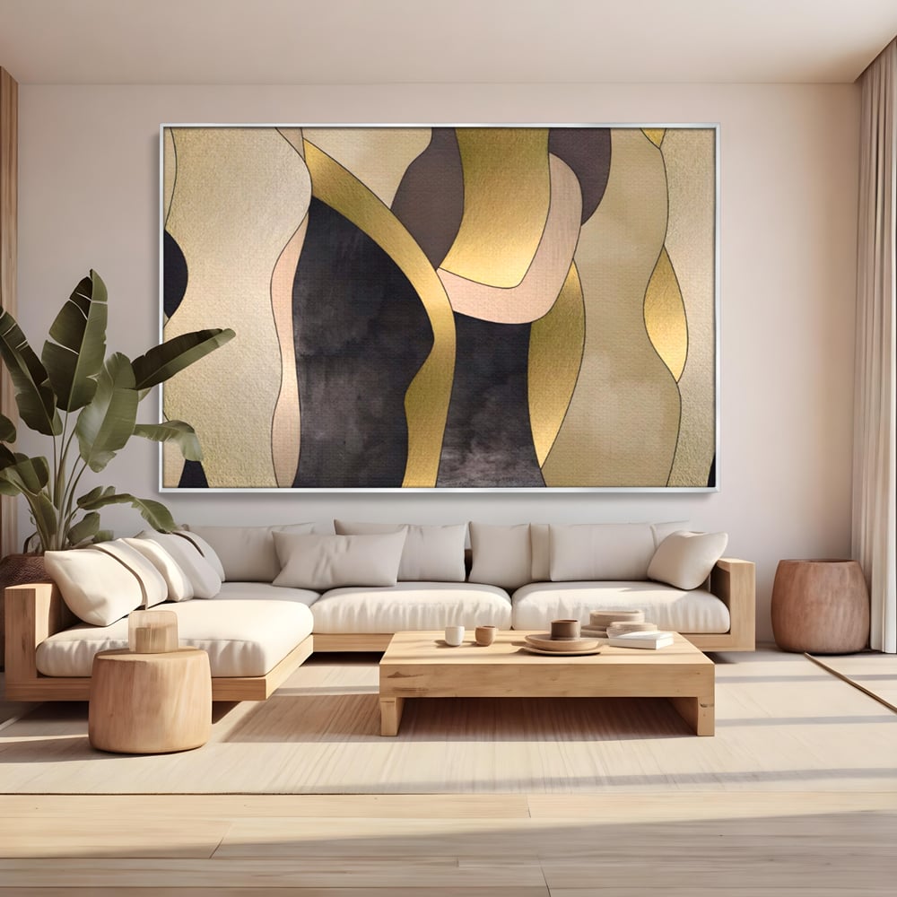 Tablou canvas cu tablou canvas cu forme abstracte aurii, in rama de aluminiu argintiu, pe perete intr-un living